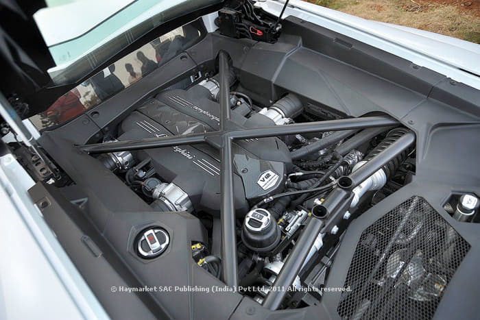 Brace for it when the V12 crosses 6000rpm. Also note race car like pushrod suspension