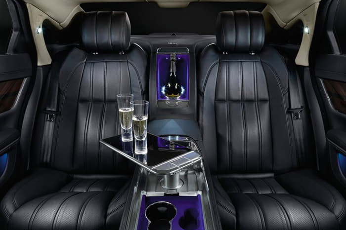 A full-length, leather-trimmed centre console separates the two individually tailored rear seats which feature power adjustment, ventilation, massage and lumbar functions. A table, machined from solid aluminium with piano-black and chrome detailing, rises up from the centre console at the touch of a button to provide a working area, its role supplemented by the provision of two third-generation iPads® with wireless keyboards that are housed in bespoke leather-trimmed docks in the rear of the front seats.