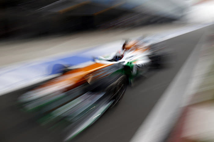 Force India's Paul Di Resta passes through the pitlane.