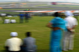 A family enjoying Formula 1 experience from the picnic stand.