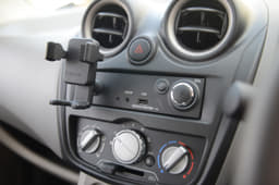 No radio or CD player. You get an aux-in port and an USB charging point.