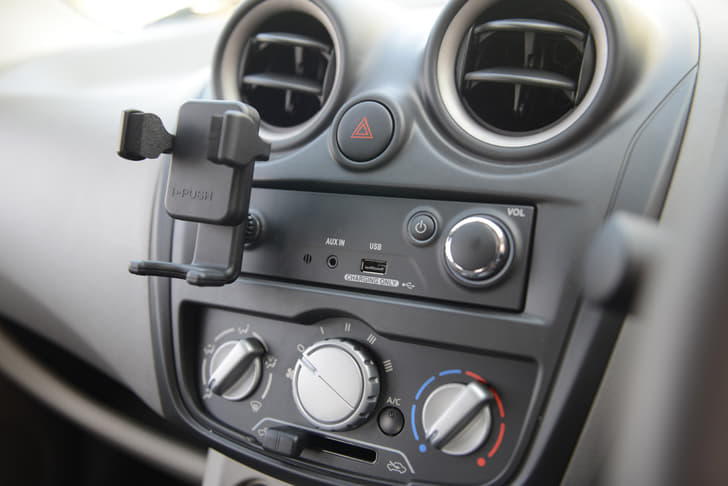 No radio or CD player. You get an aux-in port and an USB charging point.