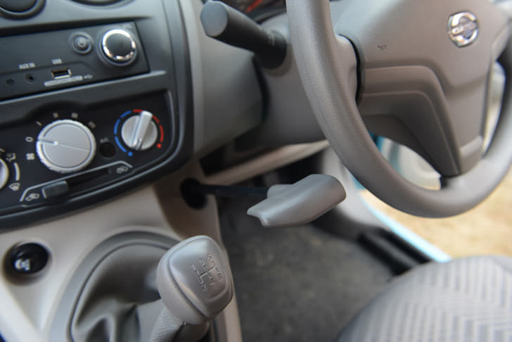 Gear lever and handbrake sprout from the dashboard.