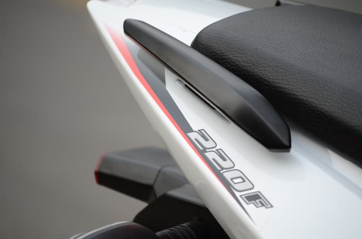 Split grab rails finished in black are provided on either side.
