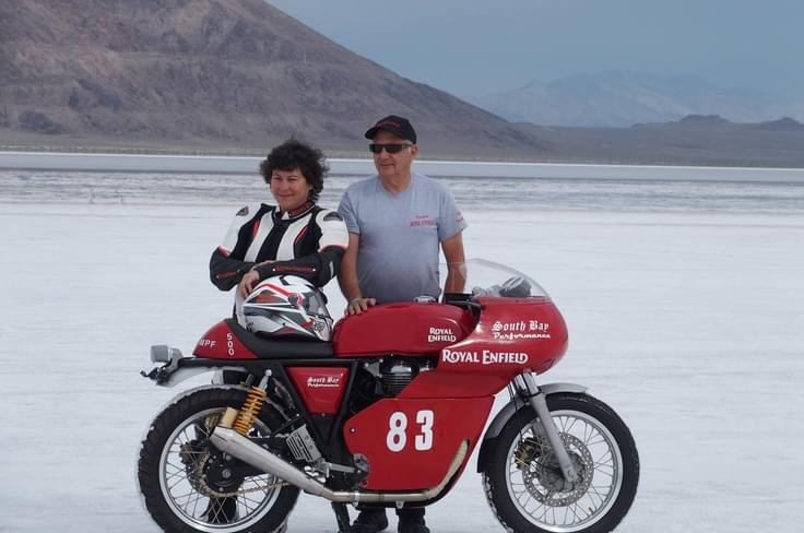 Nadine de Freitas and Matt Capri pose with speed ready Royal Enfield Continental GT at speed Mecca, the Bonneville Salt Flats. Nadine de Freitas and Matt Capri pose with speed ready Royal Enfield Continental GT at speed Mecca, the Bonneville Salt Flats.