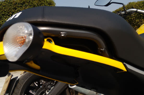Grab handles provided under the seat, do not interfere with Scrambler's unique design.