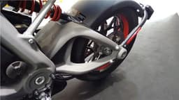 Alloy swingarm brace a work of art, meets alloy frame in a standard looking pivot.