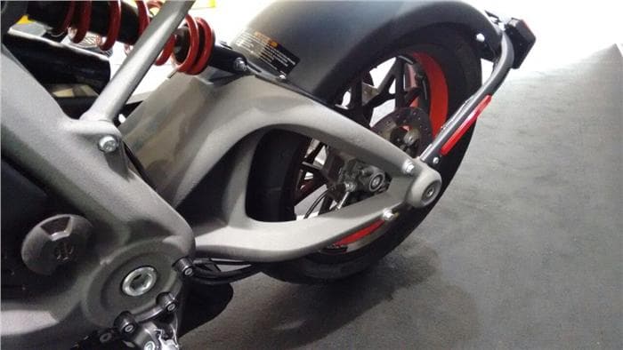 Alloy swingarm brace a work of art, meets alloy frame in a standard looking pivot.