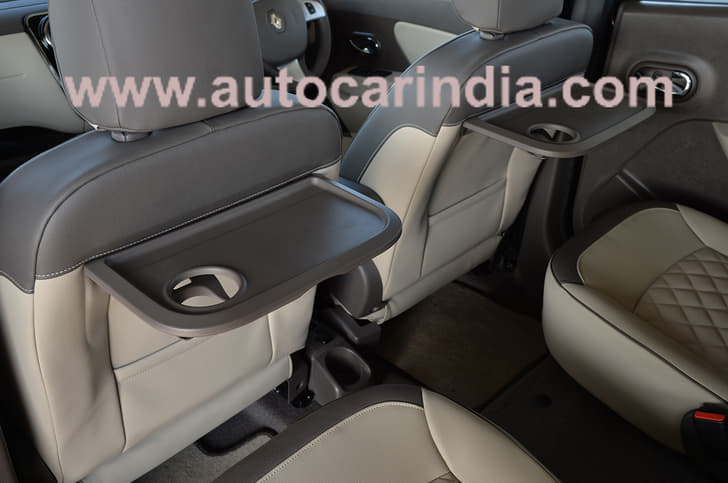 Picnic tables behind first row of seats. 