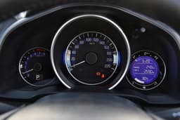 The instrument cluster and fonts are laid out like in the City, but the hood over the speedo adds a bit of flavour to the rather simple look.