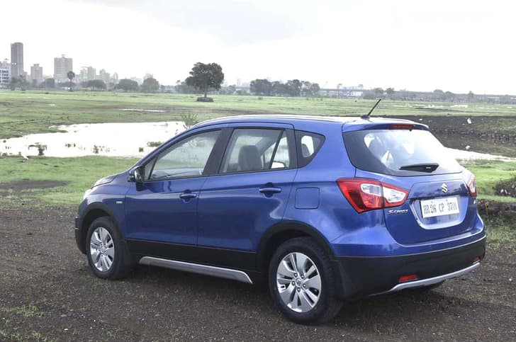 The S-Cross gets black body cladding and faux skid plates all around to give it the crossover look.
