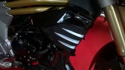 The side cowls over the radiator get scoops to deflect air away from the riders feet & engine.
