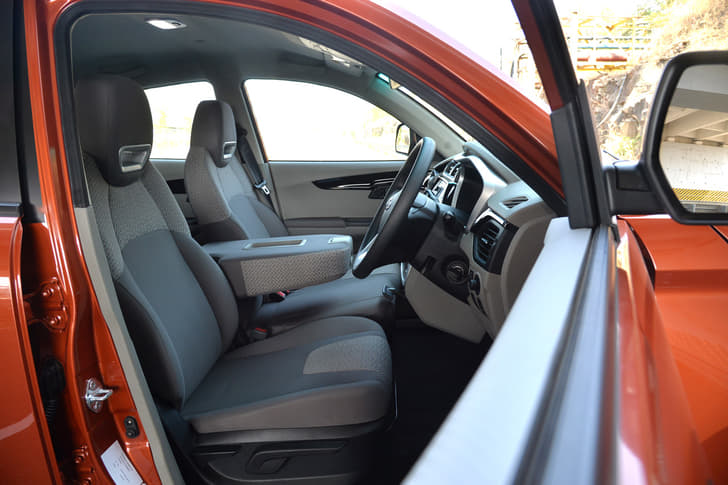 In the six-seat version KUV100, the centre seat's backrest folds down to become a large centre arm rest.