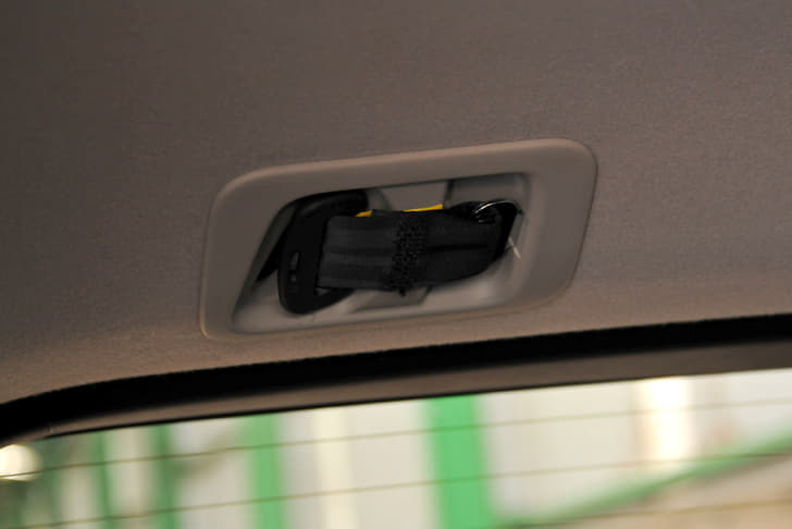 Third row middle seat has a three-point seatbelt that spools out of the ceiling.