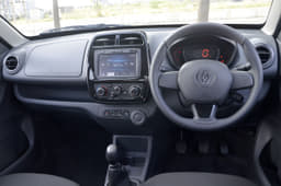 The Kwid&#8217;s dash is dominated by the large touchscreen infotainment system though the dull colours are a let-down. It also has more usable storage spaces than the Redigo.