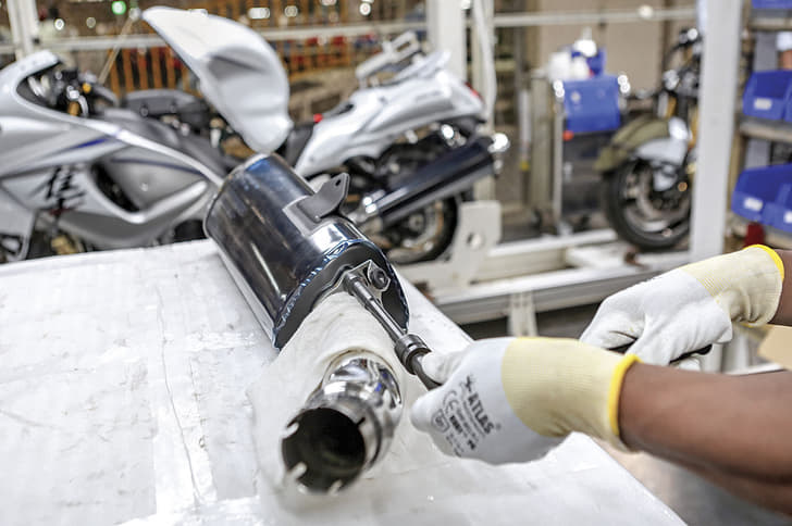 Soft cloth protects exhaust pipe while attaching end can.