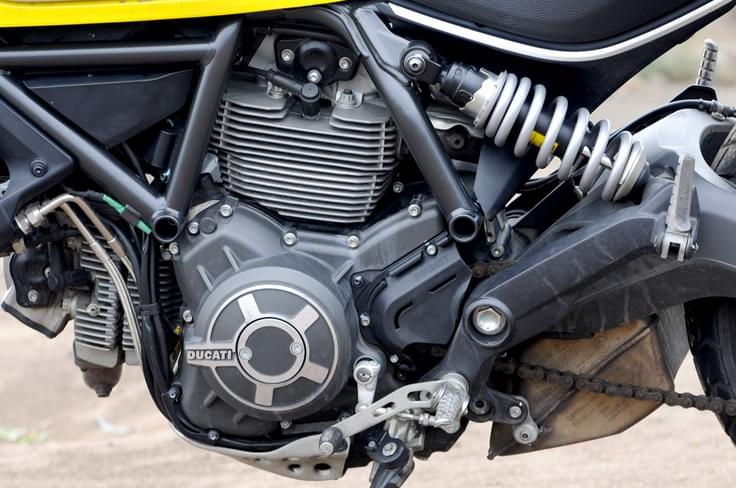 Ducati’s engineers have repurposed the 803cc air-cooled 4-valve L-twin motor from the Monster 795/796 and fiddled around with it until it suited the Scrambler’s purpose. Ducati’s engineers have repurposed the 803cc air-cooled 4-valve L-twin motor from the Monster 795/796 and fiddled around with it until it suited the Scrambler’s purpose.