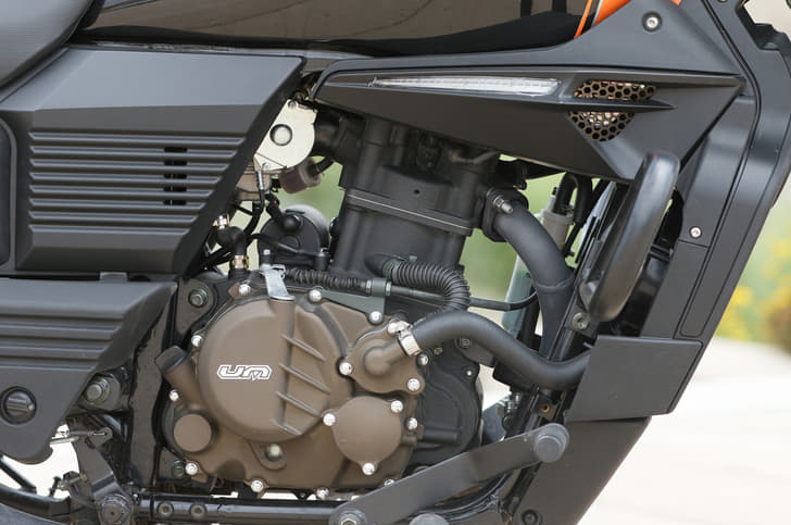 Carburetted engine is used in the same state of tune on both bikes. Ultra tall gearing blunts responsiveness of this motor. 