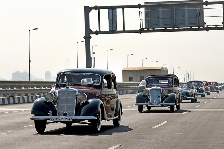 Mercedes-Benz 170Vs, 190SL and a long line of pristine classics drive down the sea link. Mercedes-Benz 170Vs, 190SL and a long line of pristine classics drive down the sea link.