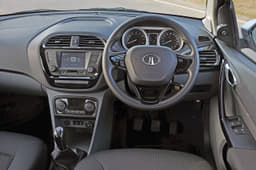 The Tigor shares its dashboard with the Tiago. However, the revised centre console is home to a new touchscreen infotainment system and automatic climate control dials.