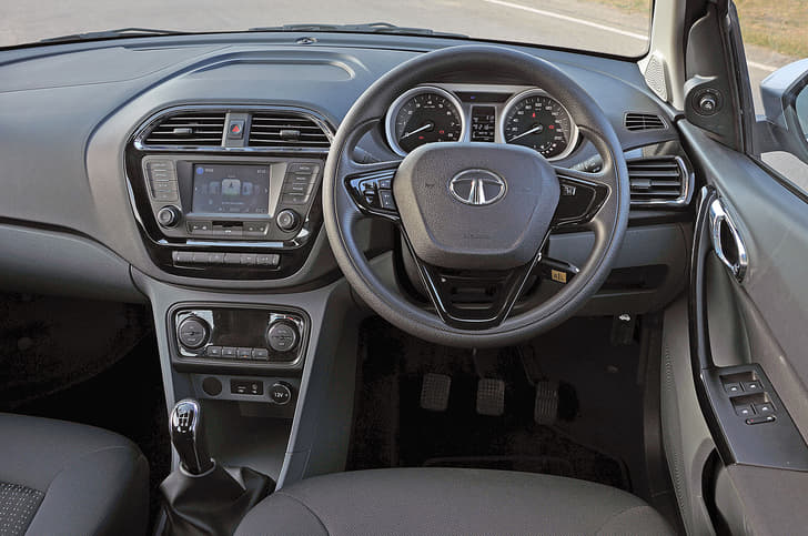 The Tigor shares its dashboard with the Tiago. However, the revised centre console is home to a new touchscreen infotainment system and automatic climate control dials.