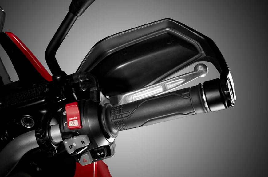 Knuckle guards are standard as expected; right switchgear holds controls for DCT operation.