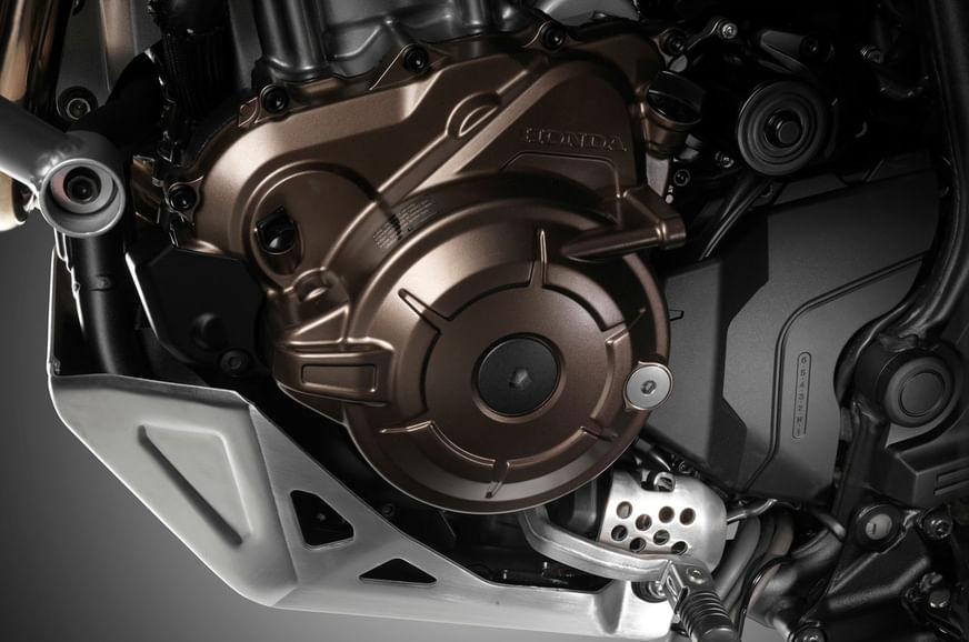 The parallel-twin engine and DCT gearbox is protected by a scuff plate at the bottom.