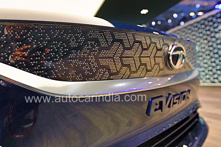 Faux grille bejewelled with pins in a tri-arrow pattern. 