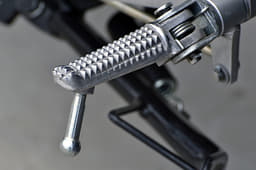 Knurled metal footpegs are grippy.