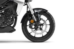 The CB uses a 296mm disc and a four-pot caliper at the front.