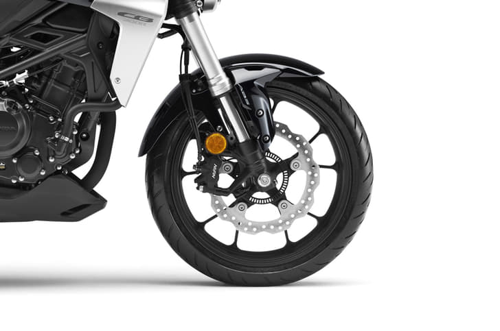 The CB uses a 296mm disc and a four-pot caliper at the front.