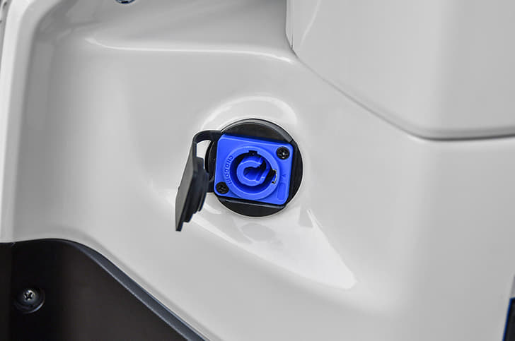 The charging port on the TVS iQube is located on the inside of the apron.