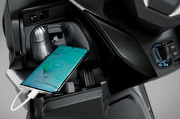 The enclosed cubby hole behind the front apron houses a USB port, as well as space to store a phone and a water bottle.