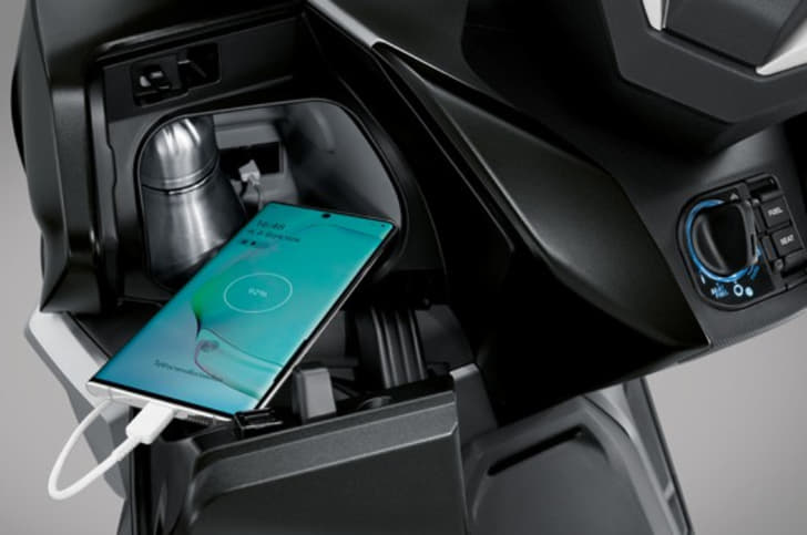 The enclosed cubby hole behind the front apron houses a USB port, as well as space to store a phone and a water bottle.