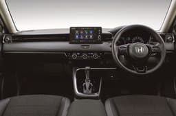 Cabin features a minimalist layout with limited control surfaces on the dash. Multi-layered dash is bisected by a swathe of leather.