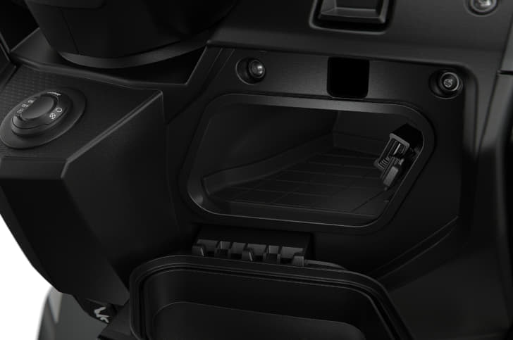 Storage cubby behind the apron houses a USB charging port.