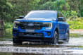 2022 Ford Everest wading through water left side view. 2022 Ford Everest wading through water left side view.