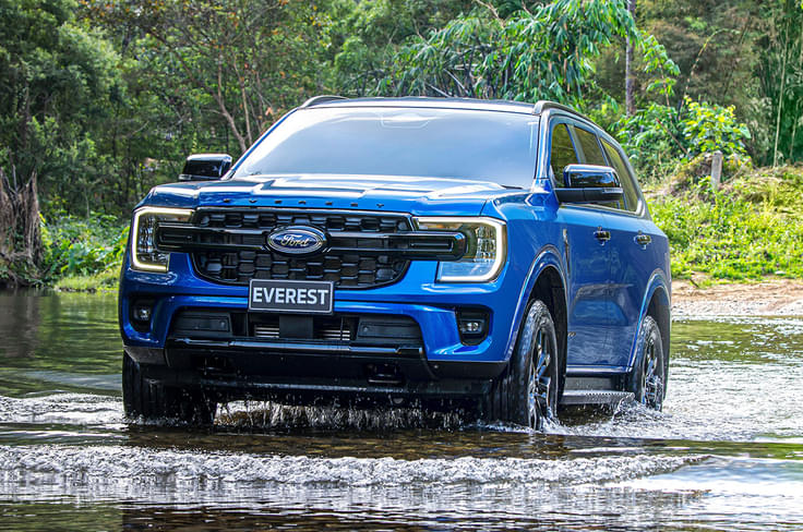 2022 Ford Everest wading through water left side view. 2022 Ford Everest wading through water left side view.