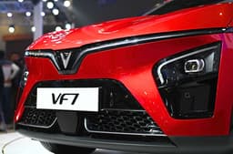 The signature 'V' motif design confirms it is a Vinfast car. Its bumper ahead houses parking sensors, LED headlights, and a front camera.
