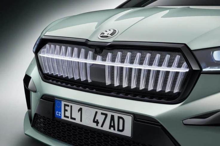 The Enyaq iV features Škoda’s signature "Crystal Face" grille, a sleek illuminated panel with geometric patterns replacing a conventional grille. The LED-lit design gives it a futuristic, aerodynamic look while maintaining Škoda’s bold family identity. grill
