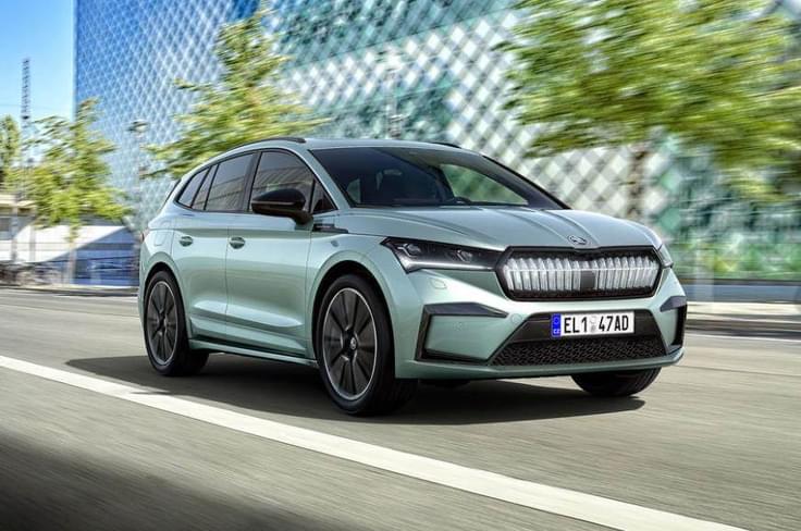 The Enyaq iV’s front is dominated by slim LED Matrix headlights, a short overhang, and a muscular hood. The lack of a traditional grille emphasizes its EV character, while the sharp creases add a dynamic edge. front view