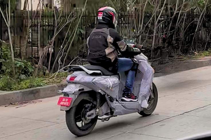 The Yamaha electric scooter will likely have more performance than the River Indie. Yamaha electric scooter rear three quarter riding spy shot
