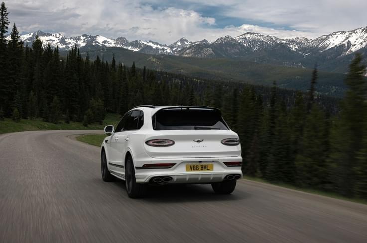 2025 Bentley Bentayga Speed rear left driving in mountains 2025 Bentley Bentayga Speed rear left driving in mountains