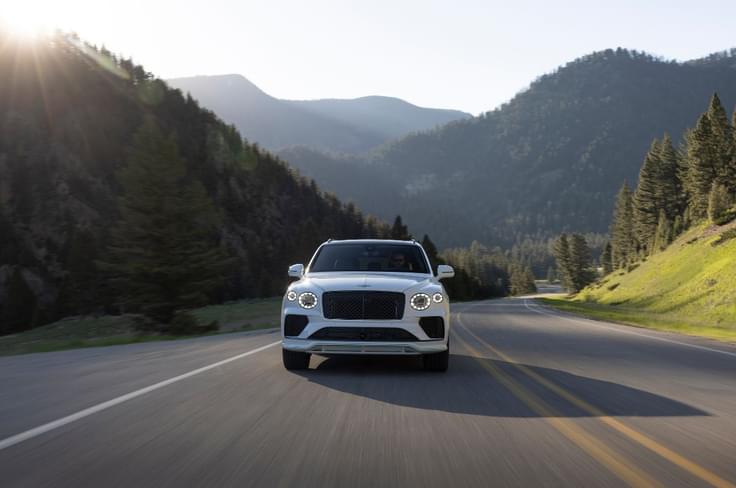 2025 Bentley Bentayga Speed front center driving in mountains 2025 Bentley Bentayga Speed front center driving in mountains