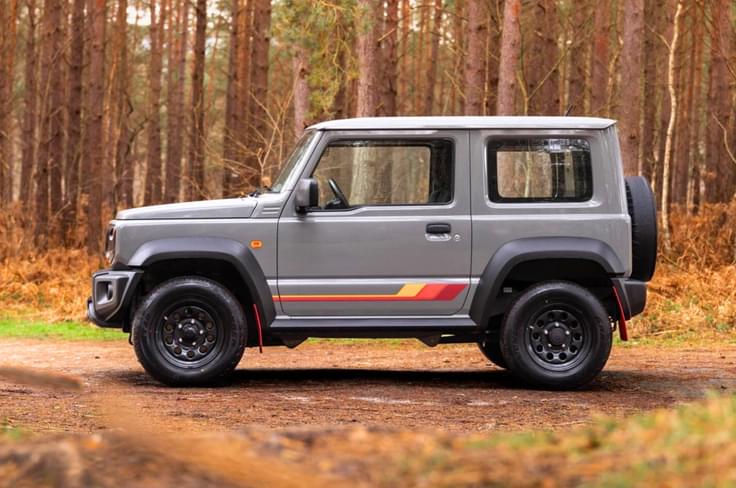 Suzuki Jimny 55th Anniversary Edition side profile in forest Suzuki Jimny 55th Anniversary Edition side profile in forest
