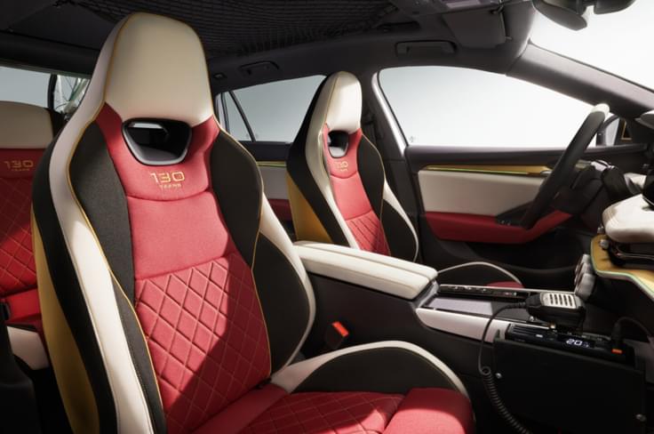 The sports seats have integrated headrests, distinct multicoloured upholstery, and embroidered ‘130 Years’ logos. Skoda Superb concept seats