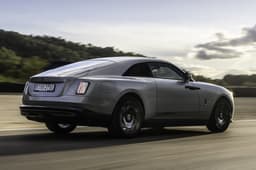 rolls royce spectre black badge in motion on road