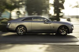 rolls royce spectre black badge side profile in motion on road