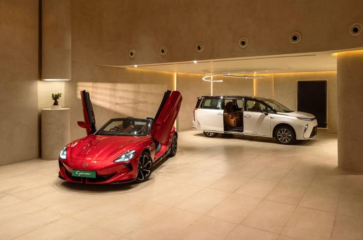 red MG cyberster and white M9 in the MG select showroom red MG cyberster and white M9 in the MG select showroom