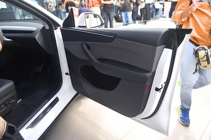 The doors are frameless, which is a nice design touch. Tesla Model Y front doors